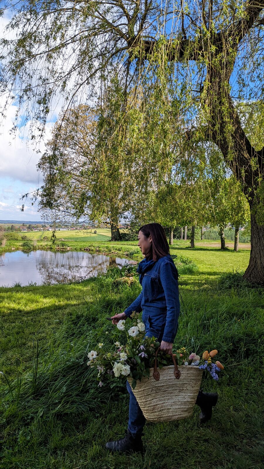 Irene gathering flowers in a garden