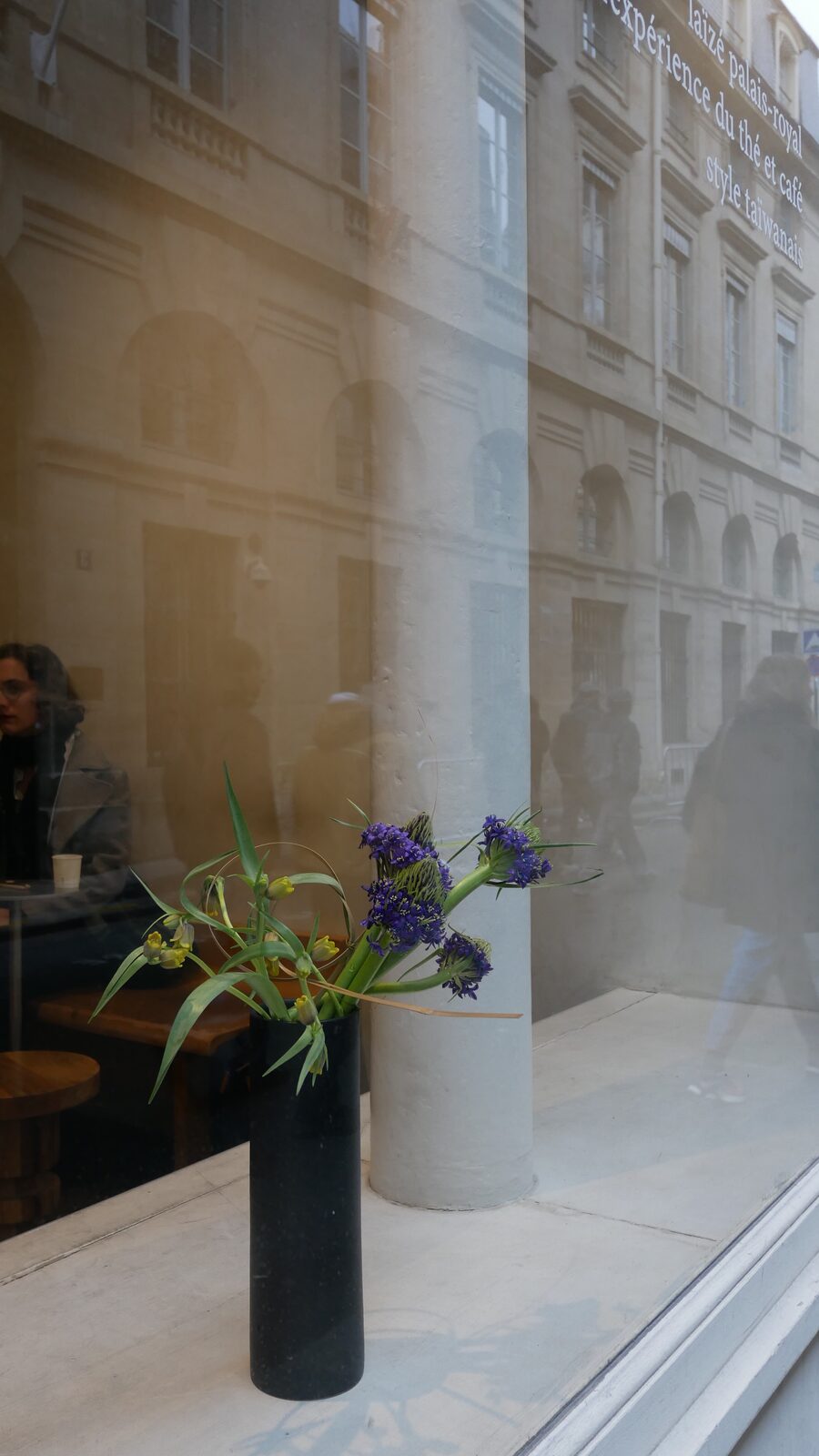 Ikebana arrangement displayed in a window